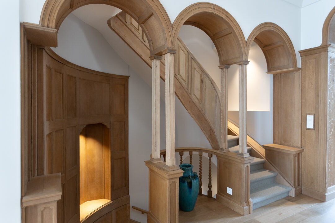 Square Marie-Louise — Trois arches de chêne en enfilade au-dessus de l'escalier